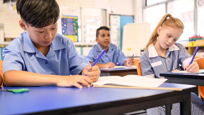 three students in an australian school classroom